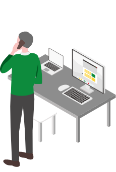 パソコンの前で電話をする人のイラスト
